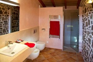 A bathroom with a sink, toilet, and shower.
