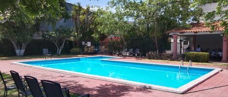 Outdoor pool, open 8:00 AM to 8:00 PM, pool loungers