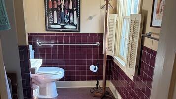 A bathroom with a toilet, bidet, and a towel rack.