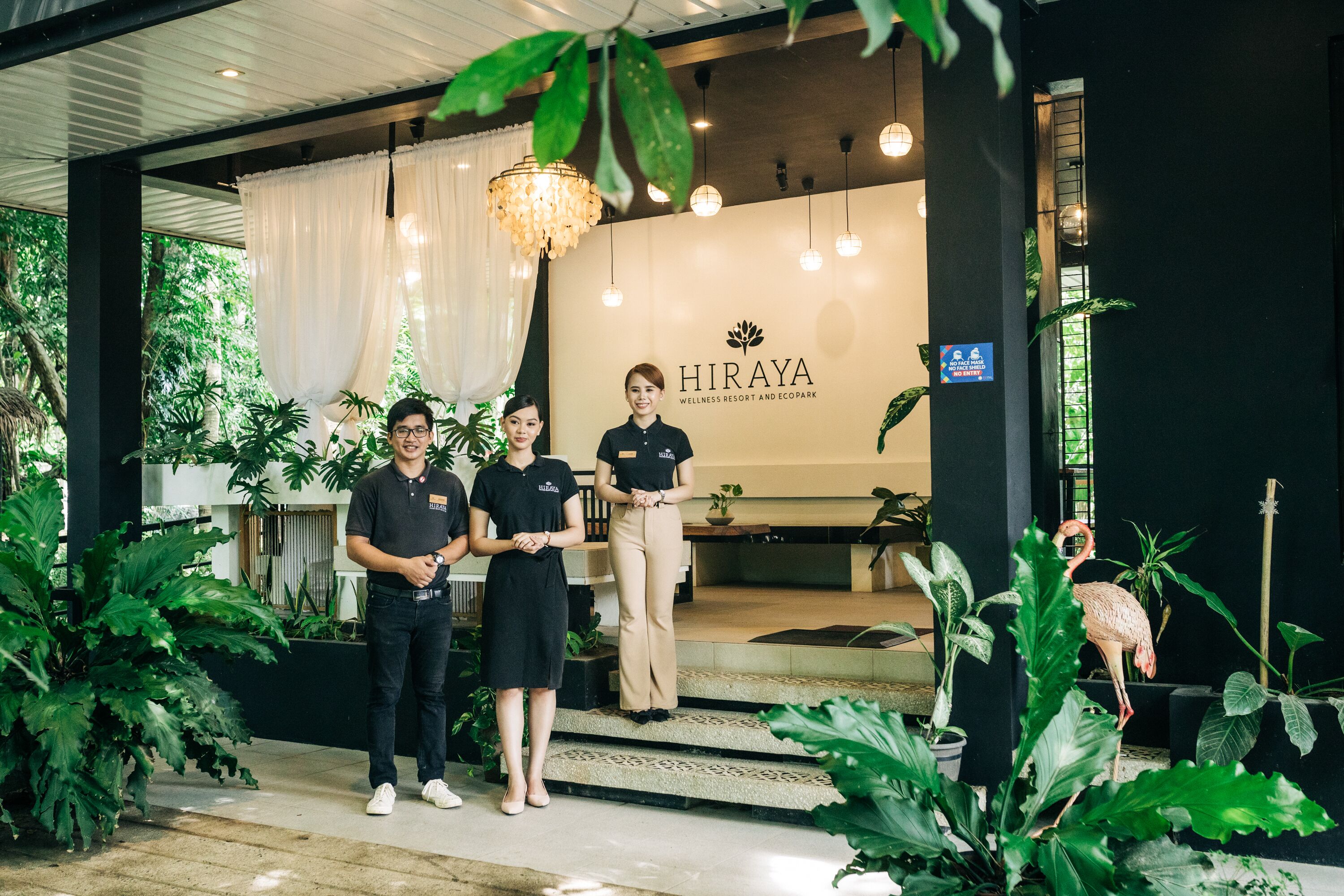A wellness resort entrance with a sign reading "HIRAYA WELLNESS RESORT AND ECOPARK".