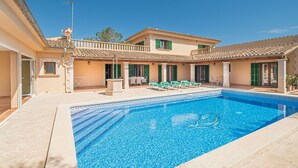A two-story building with a swimming pool, outdoor seating, and a covered patio area. - Stunning private villa for 6 people with A/C, private pool, WIFI, TV and terrace (Manacor)