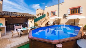 A swimming pool with a wooden deck, outdoor furniture, and a staircase leading to an upper level. - Holiday Home Casa Hermosa with Pool, Terrace, Air Conditioning and WiFi (Capdepera)