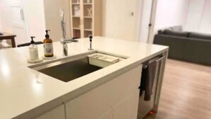 A kitchen with a sink, a faucet, and a soap dispenser. - Uptown remodeled home and heated pool (Phoenix)