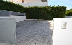 A rooftop terrace with patterned flooring, a hedge, and a white building in the background. - Charming Holiday Apartment "Casa a Torre dell'Orso PT55" with Garden (Torre dell'Orso)