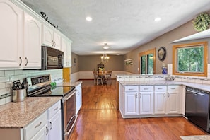 Enjoy cooking in this well-equipped kitchen with a central island, microwave, oven, and dishwasher.