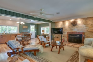 Relax in a spacious living area with a central fireplace, comfortable seating, and a flat-screen TV.