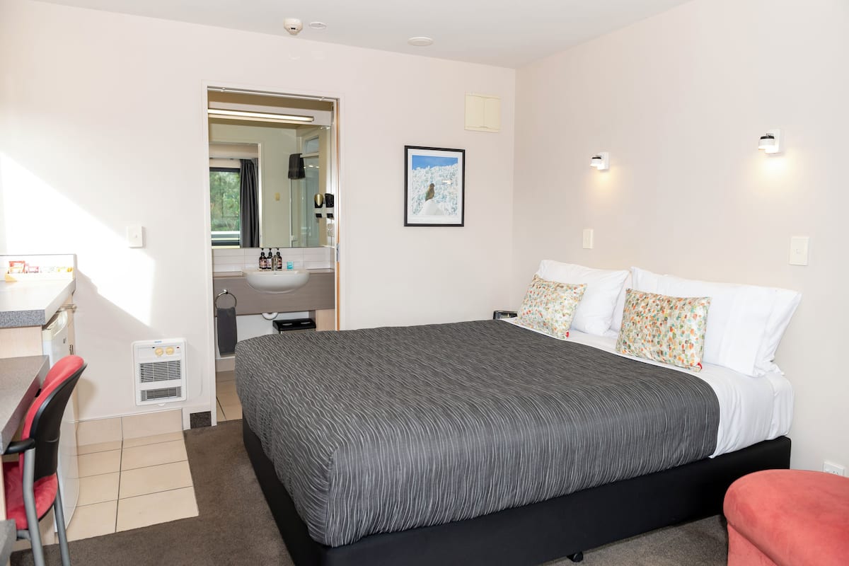 Superior Queen Studio | Desk, blackout curtains, soundproofing, iron/ironing board