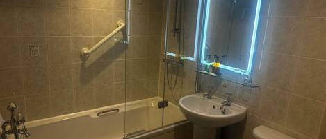 A modern bathroom with a glass-enclosed shower, a pedestal sink, and a toilet.