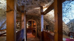 A stone-walled interior with wooden beams and a bar area. - Hotel Zum Harzer (Clausthal-Zellerfeld)
