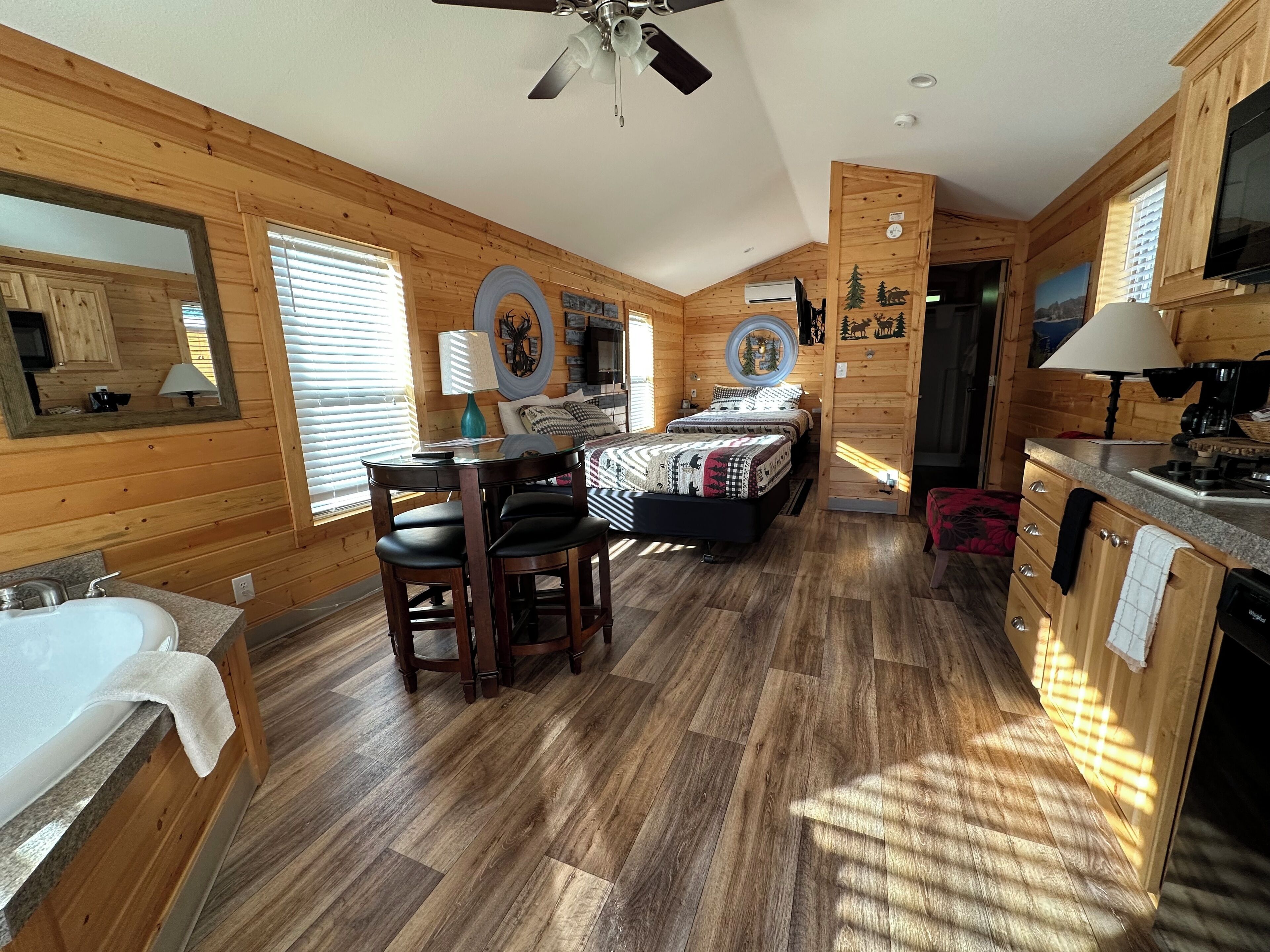 A log cabin interior with a kitchen, dining area, and two bedrooms.