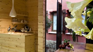Ein Holzinterieur mit Küchenzeile, Weingläsern und einer Pendelleuchte.