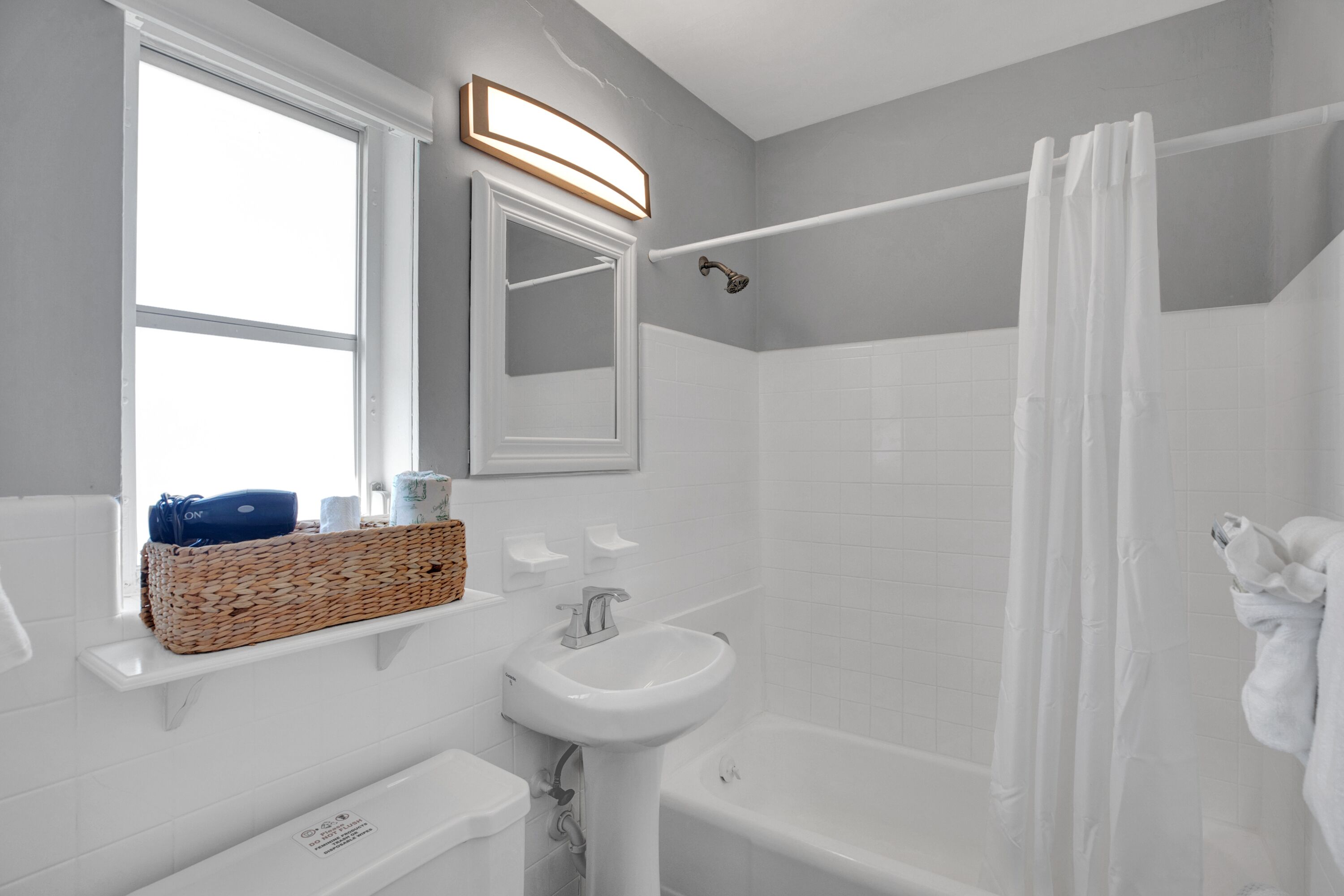 A modern bathroom with a bathtub, a sink, and a shower.
