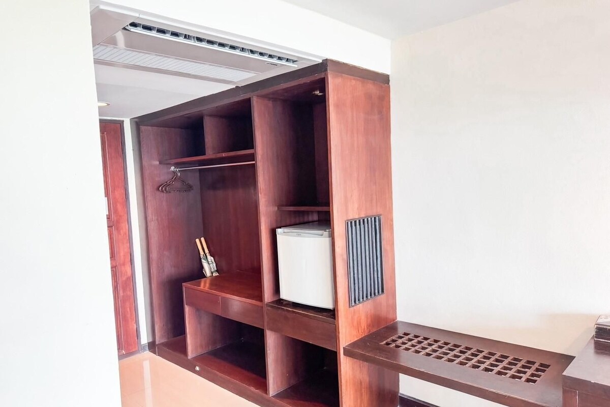 A walk-in closet with multiple shelves and a built-in appliance.