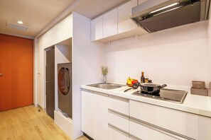 A modern kitchen with a built-in oven, a sink, and a stove.