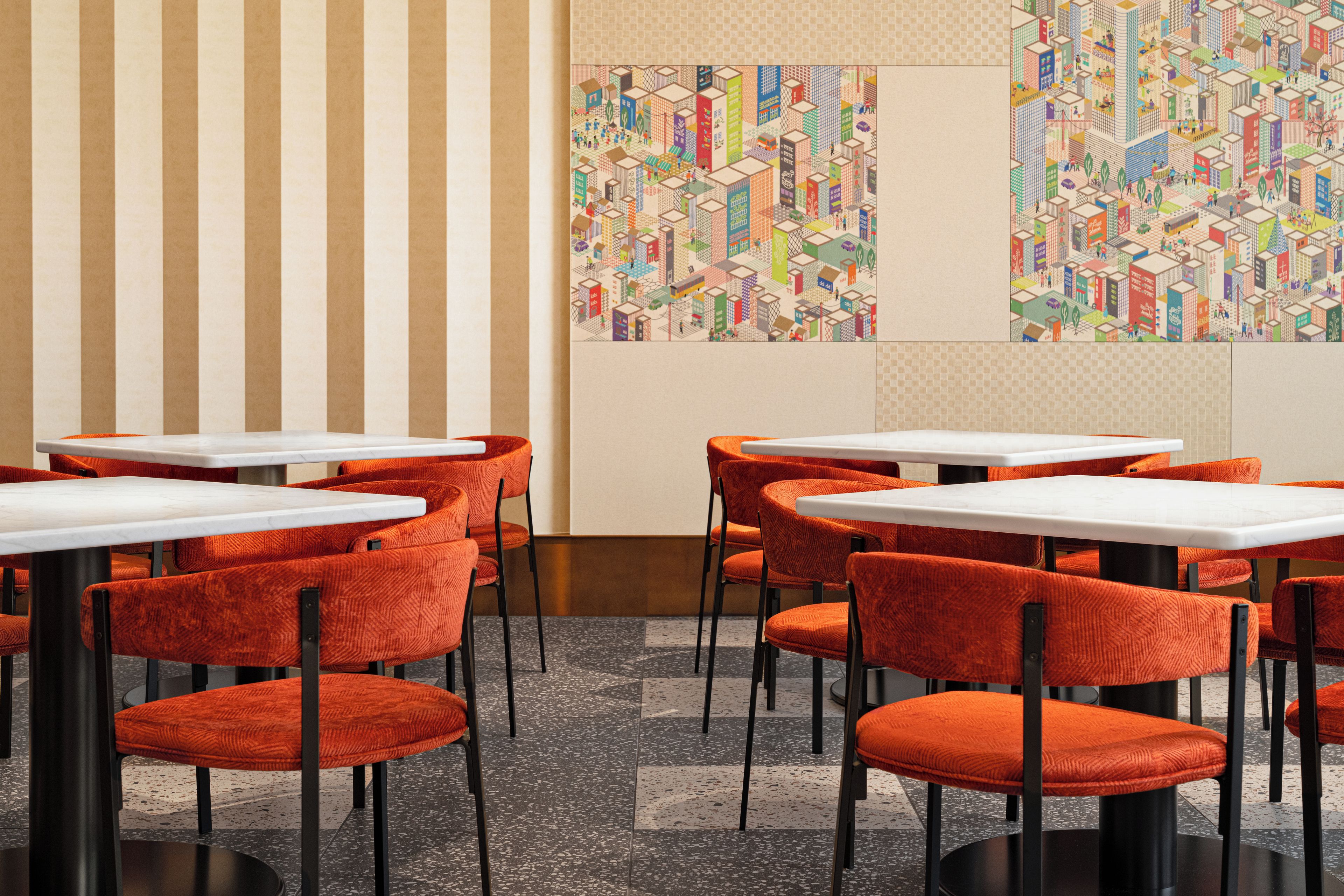 Interior de restaurante con paredes a rayas, sillas tapizadas en rojo y mesas blancas.
