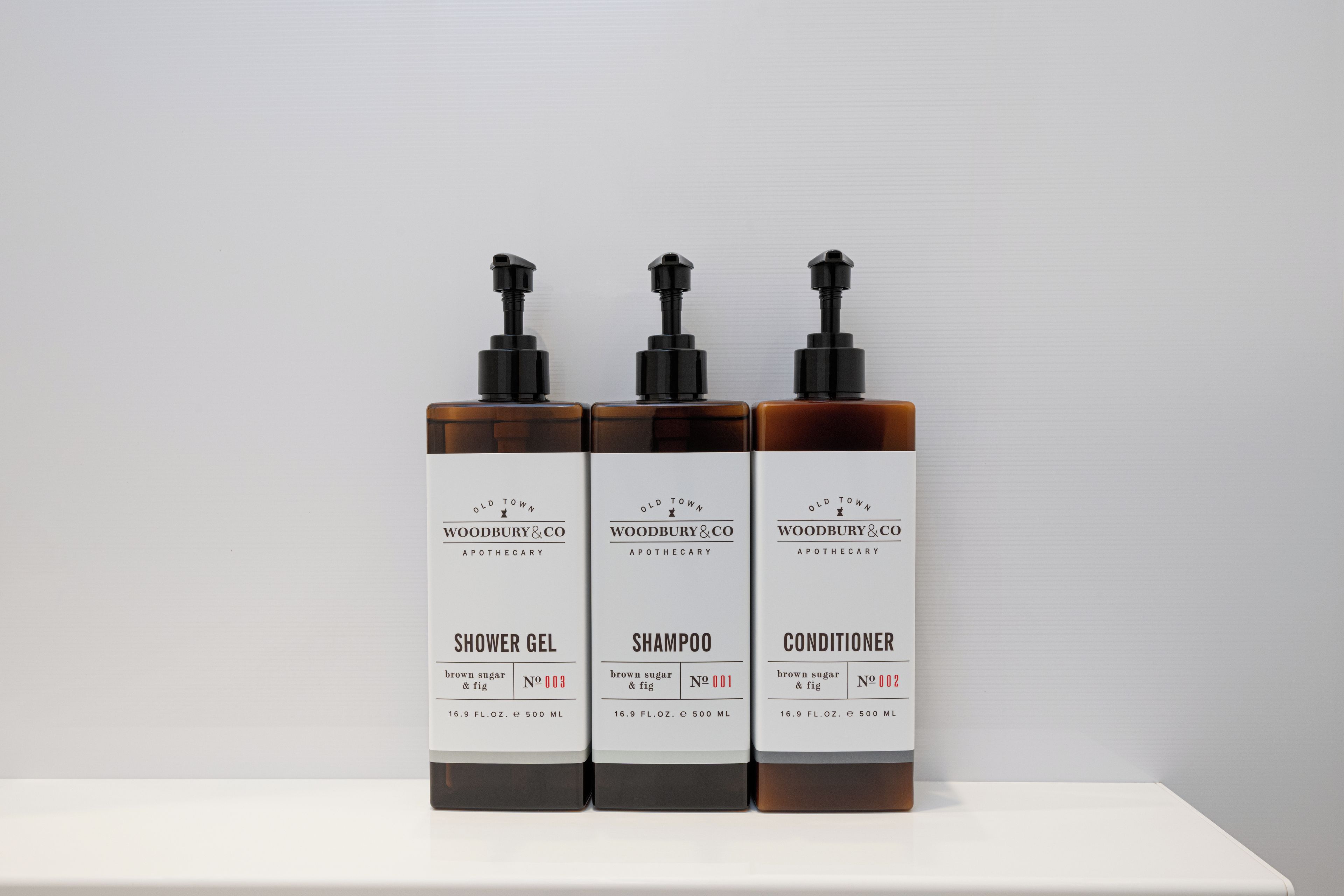 Three bottles of Old Town Woodbury & Co. products on a white surface.