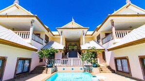 A large, two-story building with a central staircase leading to a covered entrance. - Haadson Resort (Ko Pha-ngan)