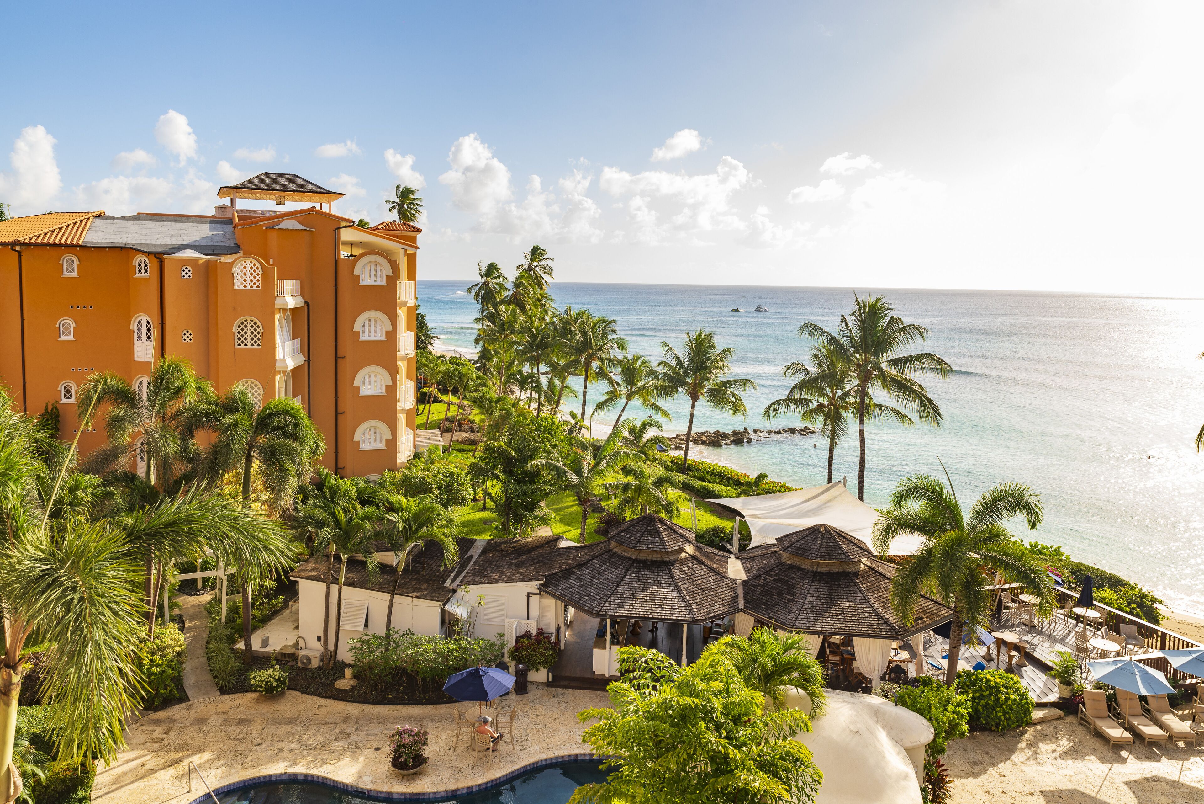 A resort with a pool, beach, and ocean view.