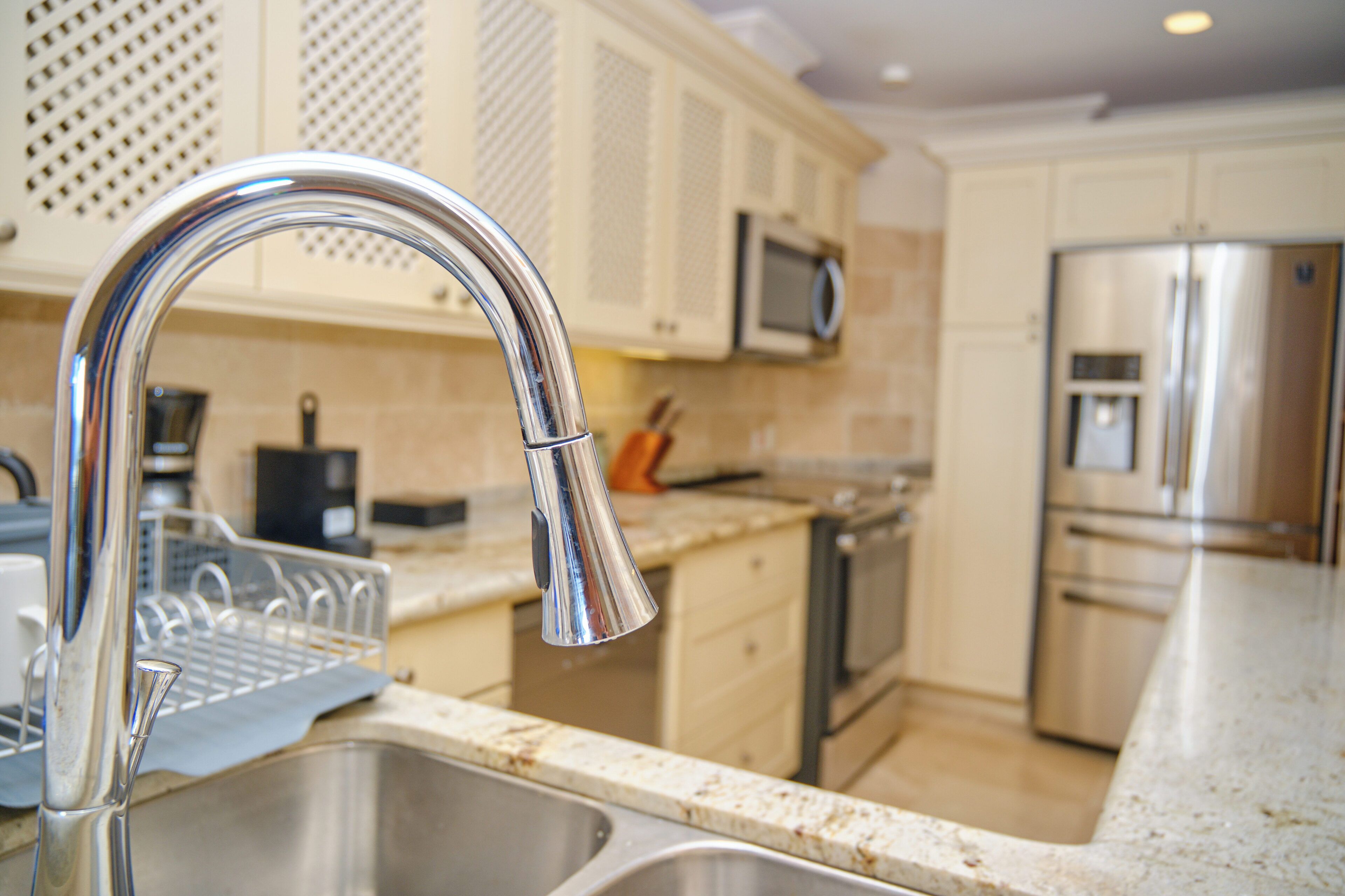 A kitchen with stainless steel appliances, a microwave, and a dishwasher.