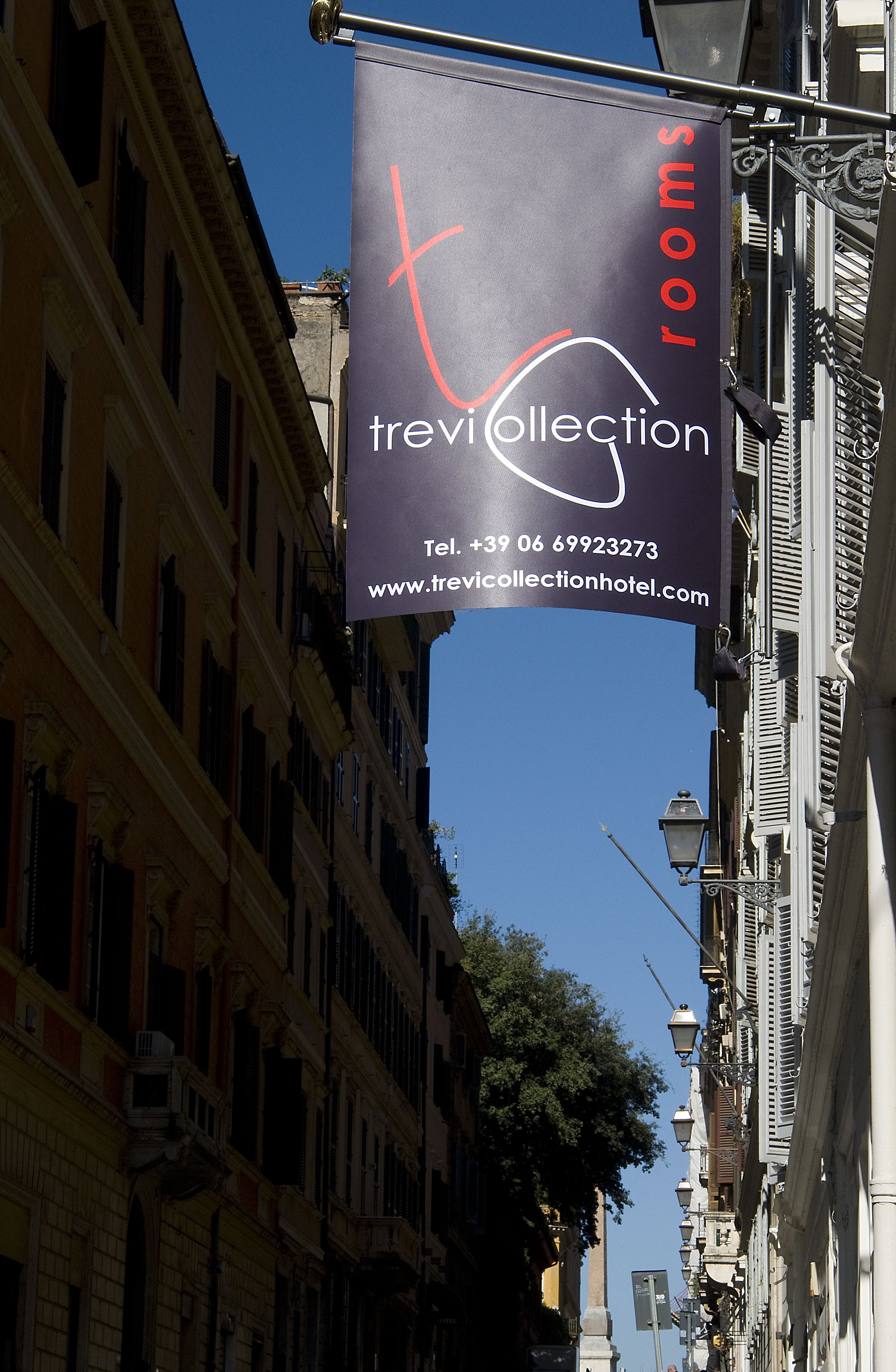 A banner advertising Trevi Collection rooms with contact information and a website URL.