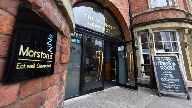 The exterior of The Wynstay Arms Hotel with a signboard advertising room hire for events. - Wynnstay Arms, Wrexham by Marston's Inns (Wrexham)