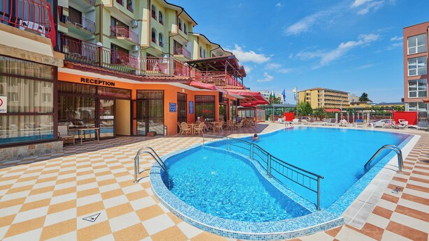A hotel with a reception area, a swimming pool, and outdoor seating. - Smolian (Nessebar)