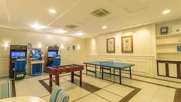 Enjoy games and leisure activities in this well-designed room featuring arcade machines, a foosball table, and a ping pong table.