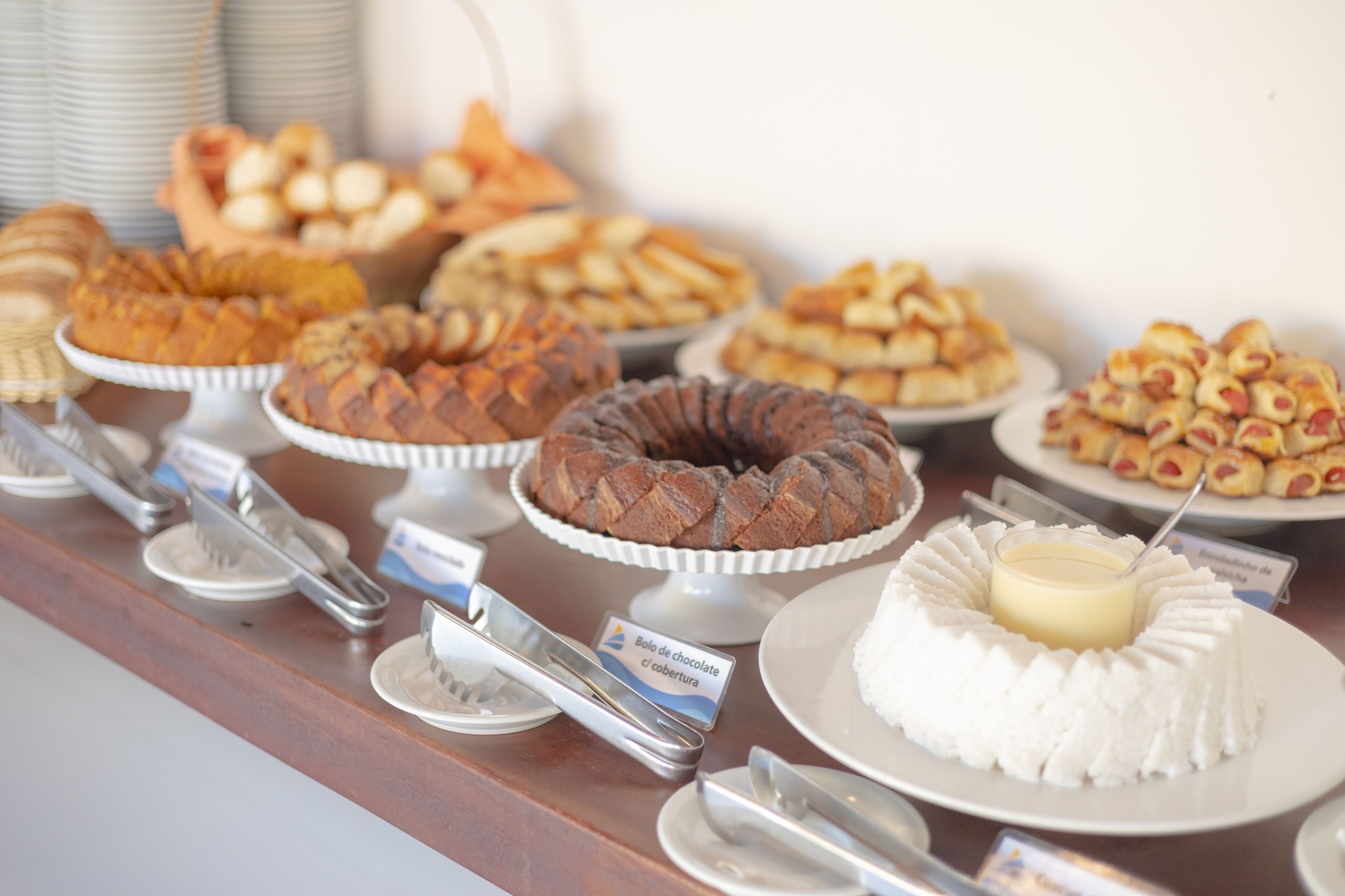 A buffet with various baked goods including cakes and pastries.