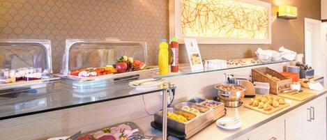 A buffet with various food items and condiments.