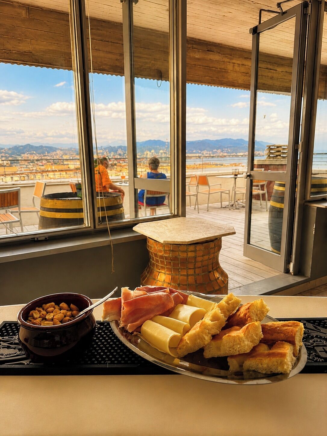 A dining area with a view of a cityscape through large windows.