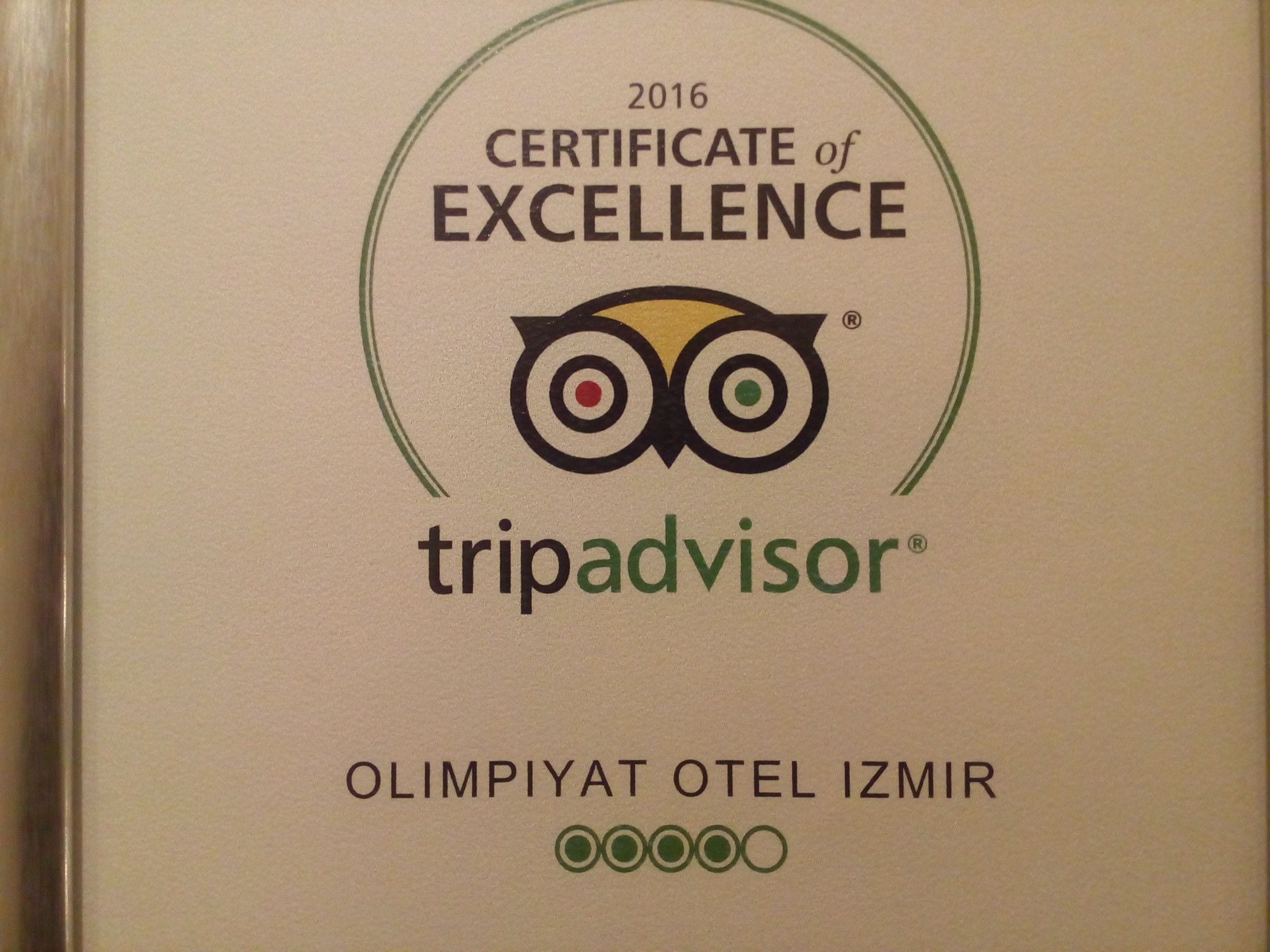 A certificate of excellence from TripAdvisor for Olimpiyat Otel İzmir, featuring the TripAdvisor logo and a stylized owl.