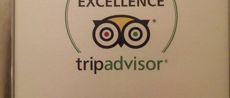 A certificate of excellence from TripAdvisor for Olimpiyat Otel İzmir, featuring the TripAdvisor logo and a stylized owl.