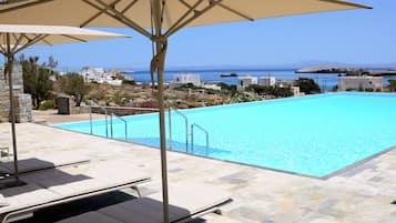 Seasonal outdoor pool, open 8:30 AM to 7:30 PM, pool umbrellas