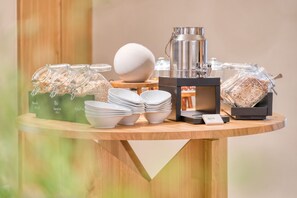 A buffet setup with various food items, including jars of grains and a coffee machine. - Hotel Bad Minden (Minden)