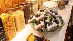 A buffet setup with various food items and condiments. - Howbeck Guest House (Windermere)