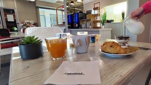 A breakfast table with a croissant, a glass of orange juice, a bowl of jam, and a pitcher of milk. - The Originals Access, Hôtel les Iris (Berck-sur-Mer)