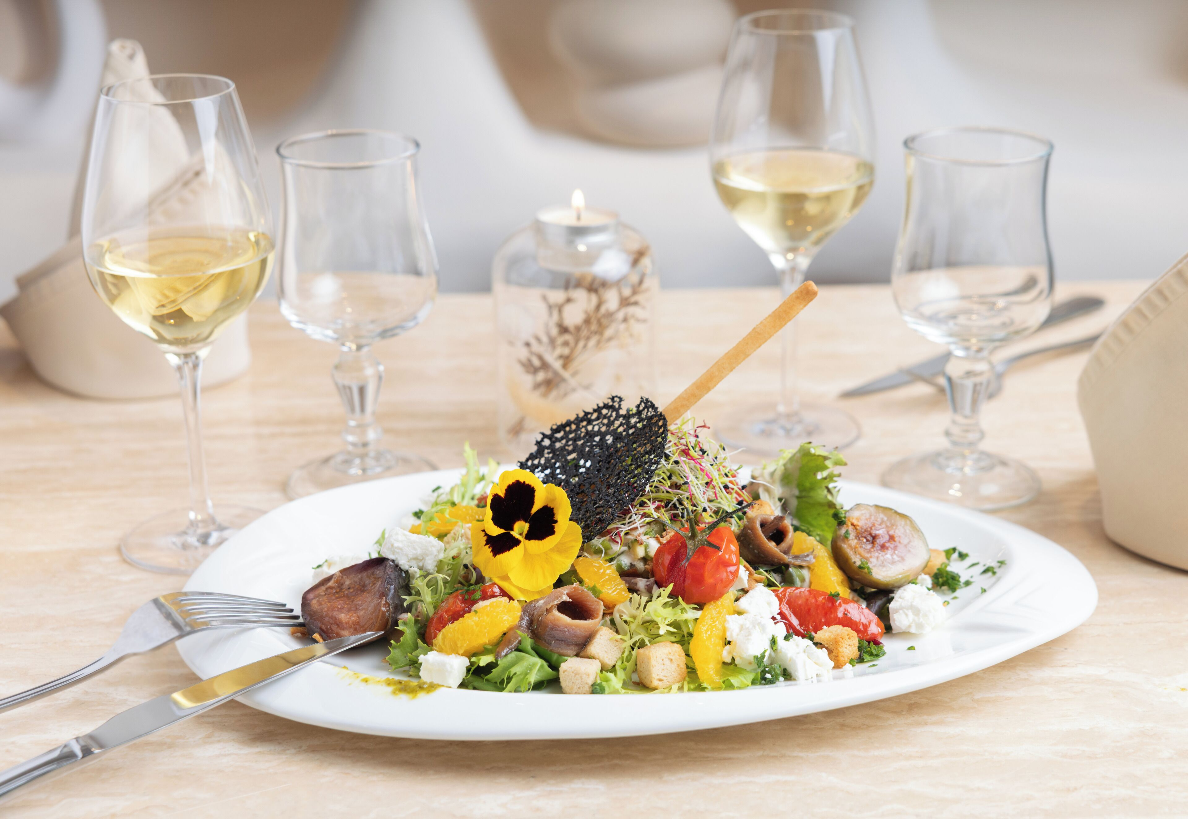 A plate of food with a fork and knife on a table.