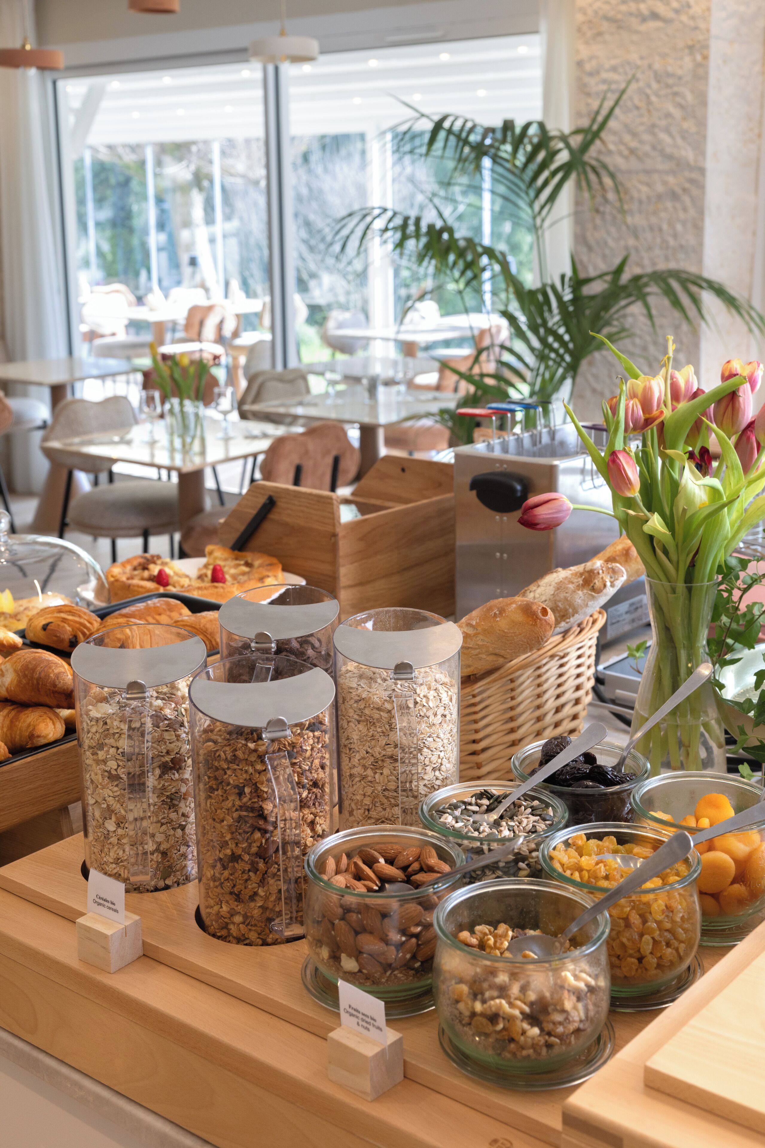 A breakfast buffet with various food items and a view of the outdoors.