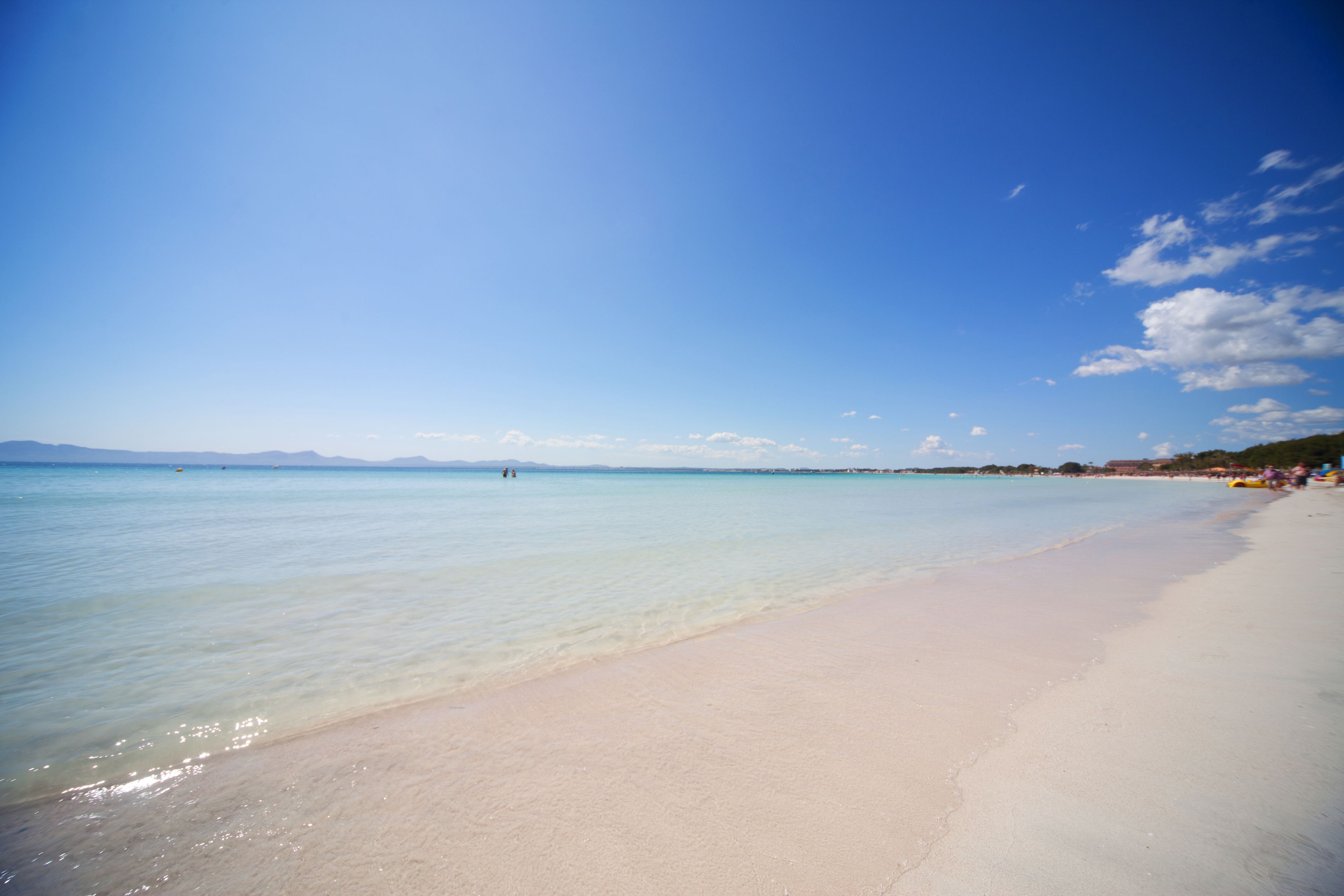 In Strandnähe, weißer Sandstrand, Liegestühle, Sonnenschirme