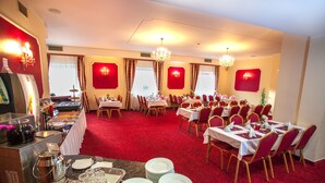 A banquet hall with tables set for dining, a buffet area, and a bar. - Savoy (Ceske Budejovice)