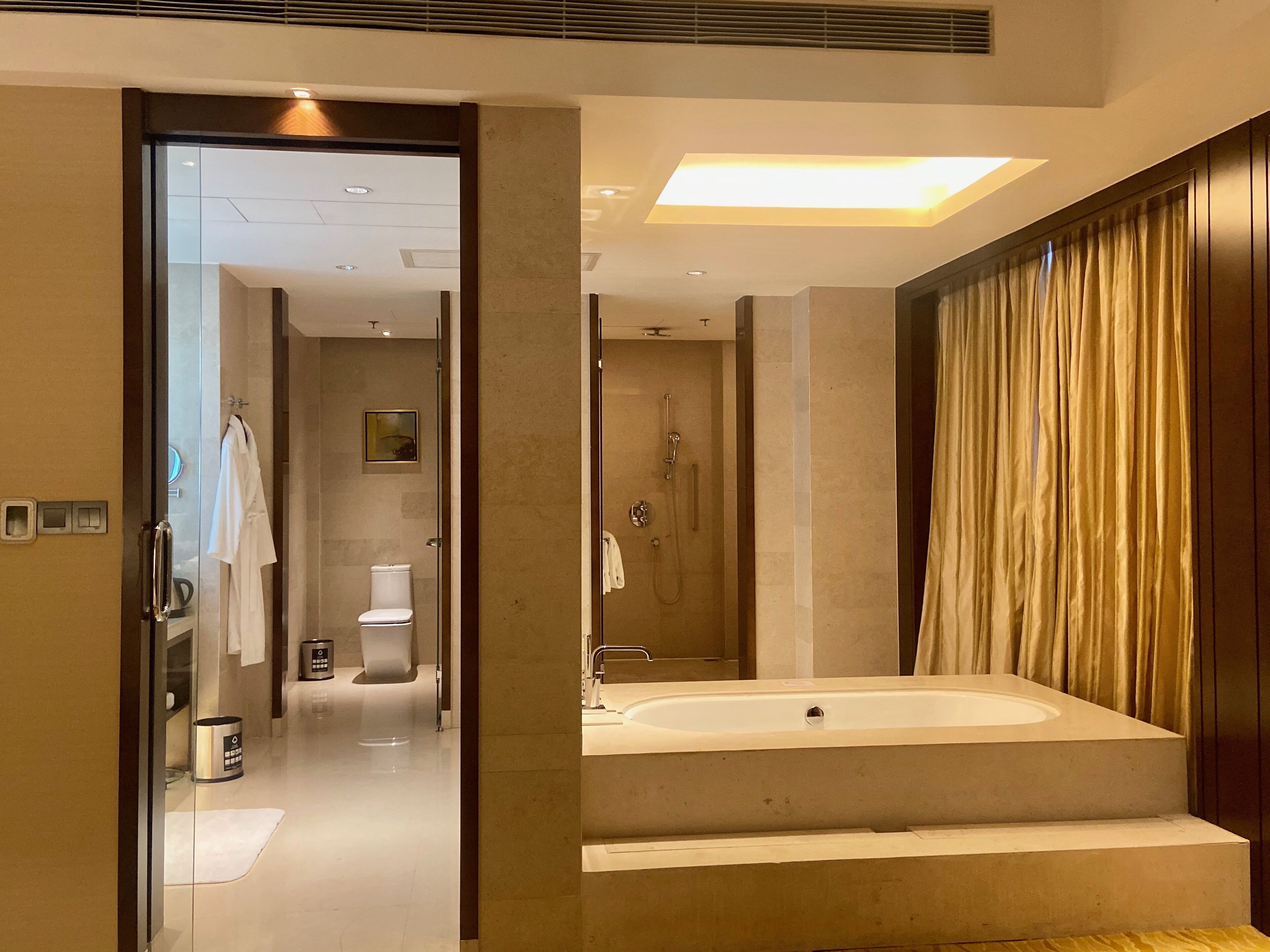 executive suite, 1 king bed, non smoking, city view | bathroom | separate bathtub and shower, rainfall showerhead, free toiletries