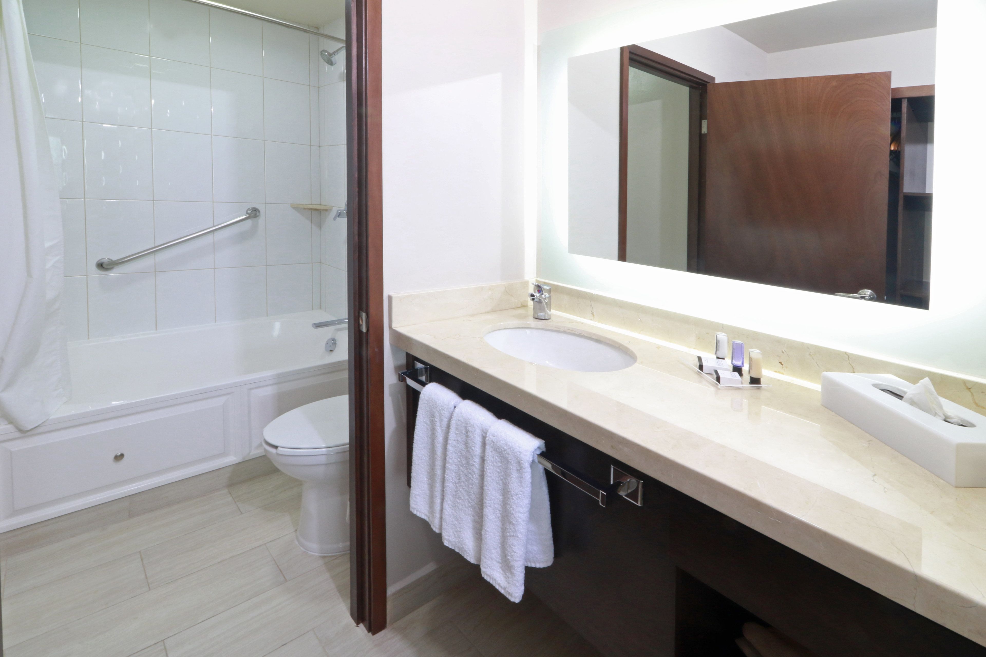 A bathroom with a bathtub, toilet, and sink.