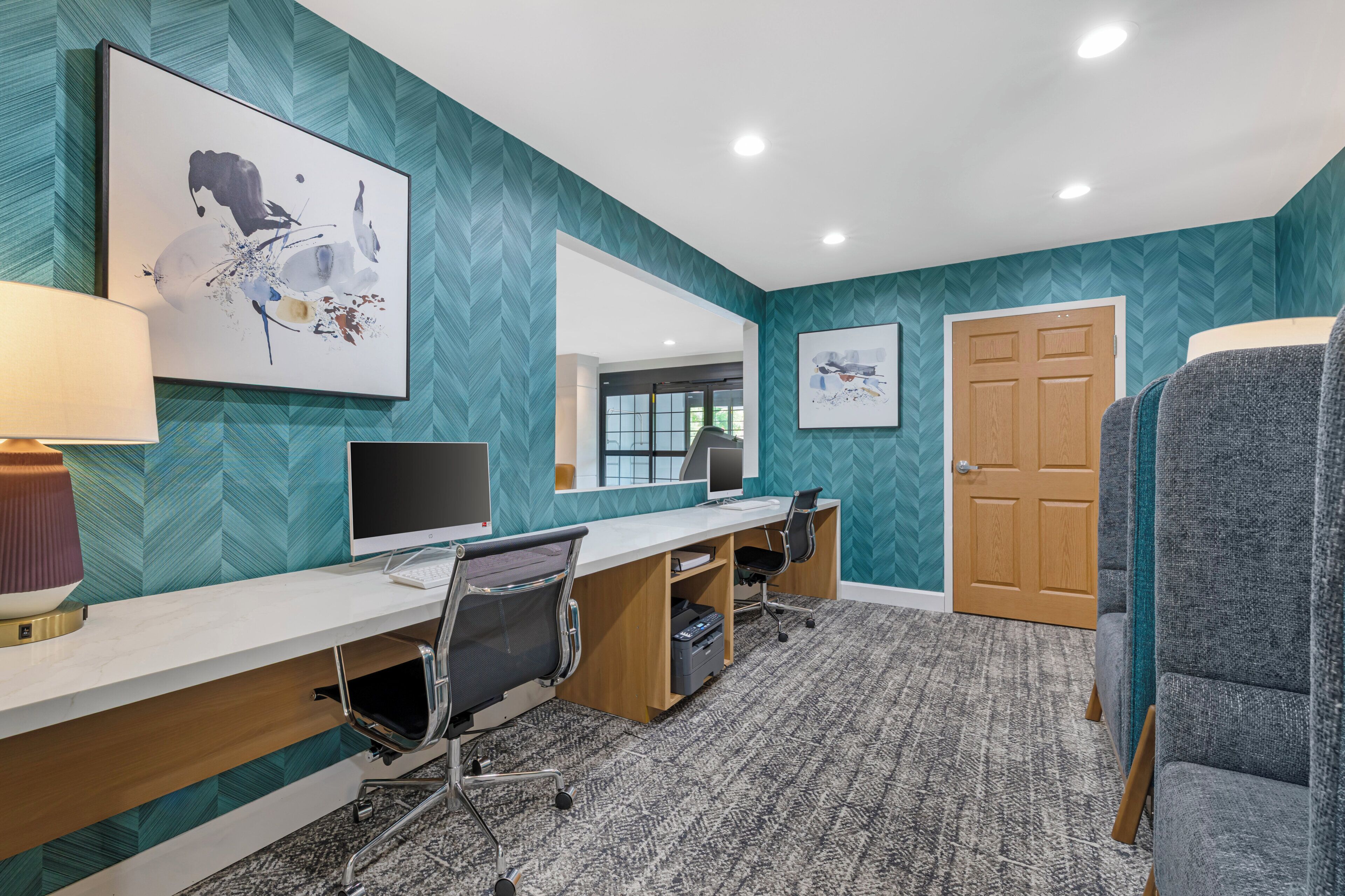 A modern office space with a desk, computer, and office chair.