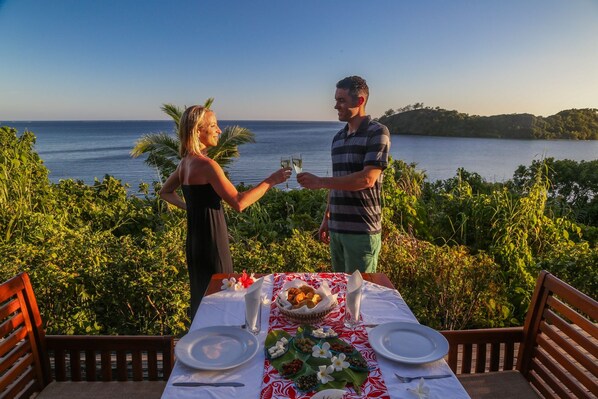 A couple dining at a table with a view of the sea. - Matava - Fiji...Untouched (Kadavu Island)