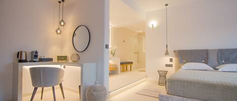 A modern bedroom with a bed, bedside table, and a desk area with a chair.