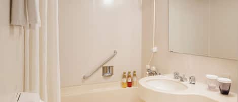 Un baño moderno con bañera, lavabo, espejo y ducha.