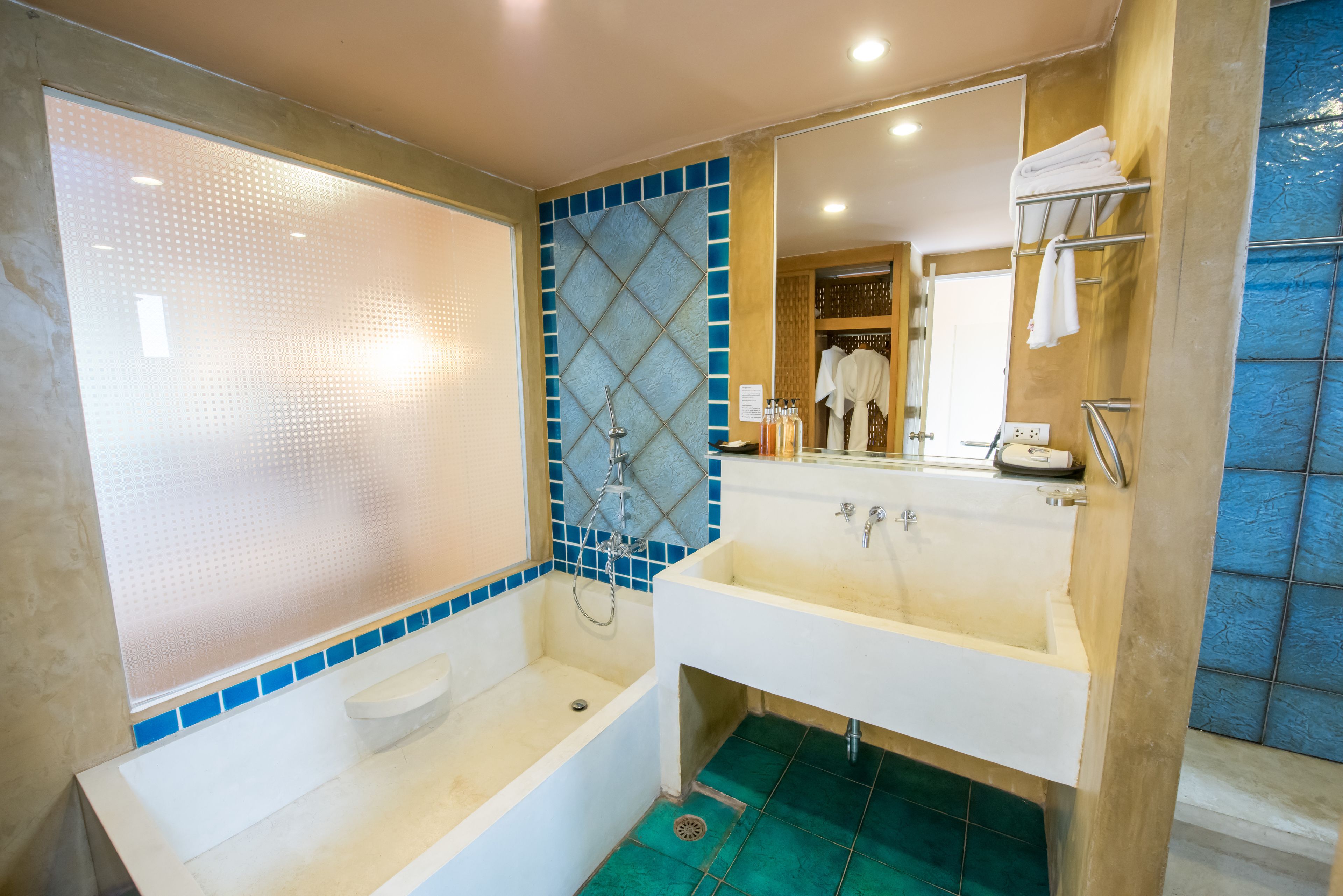 A bathroom with a bathtub, a sink, and a shower.