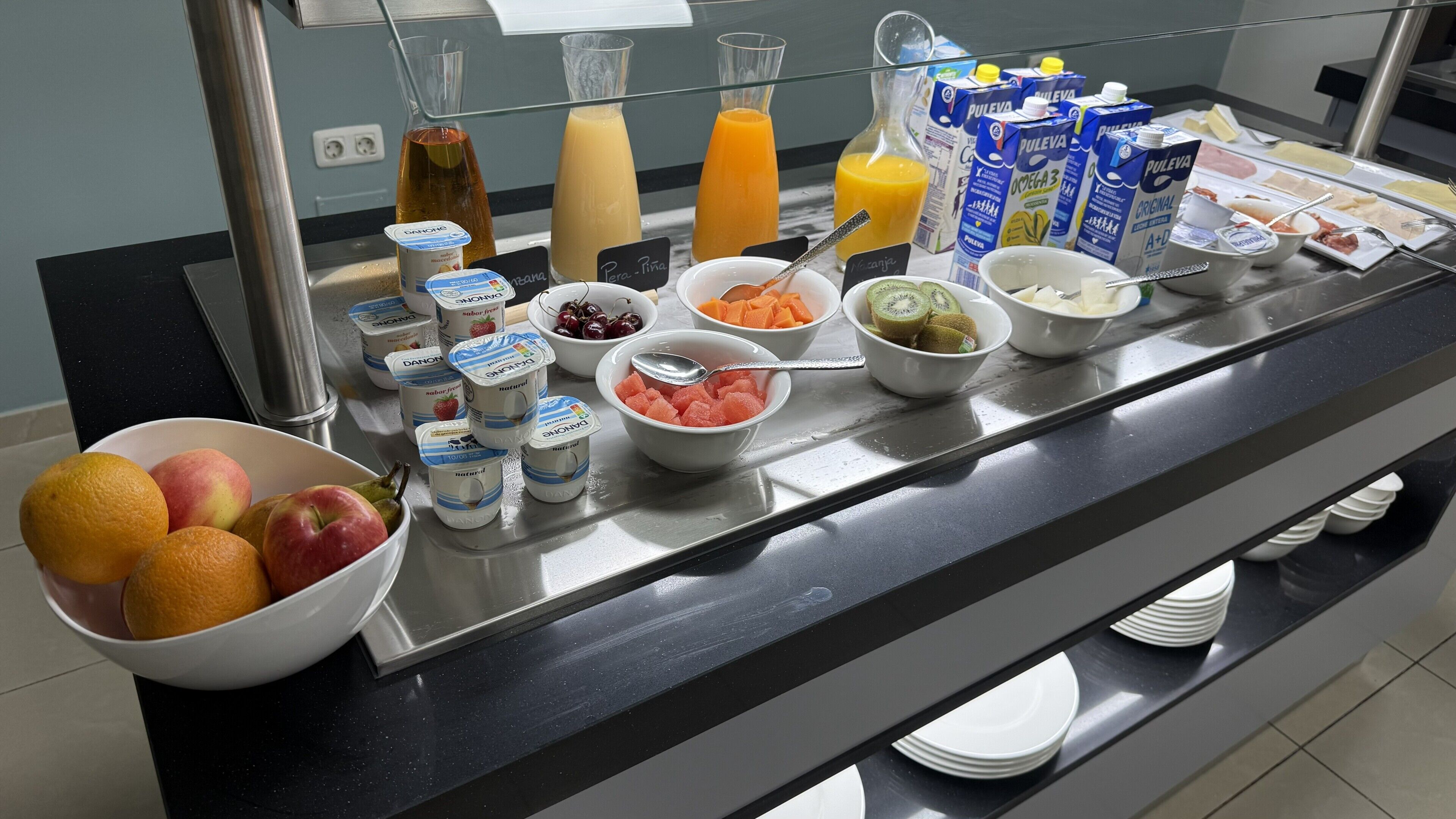 A breakfast buffet with various food items and beverages.