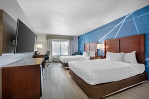 A hotel room with a large bed, a desk, a TV, and a window with curtains. - Comfort Inn Goshen (Goshen)