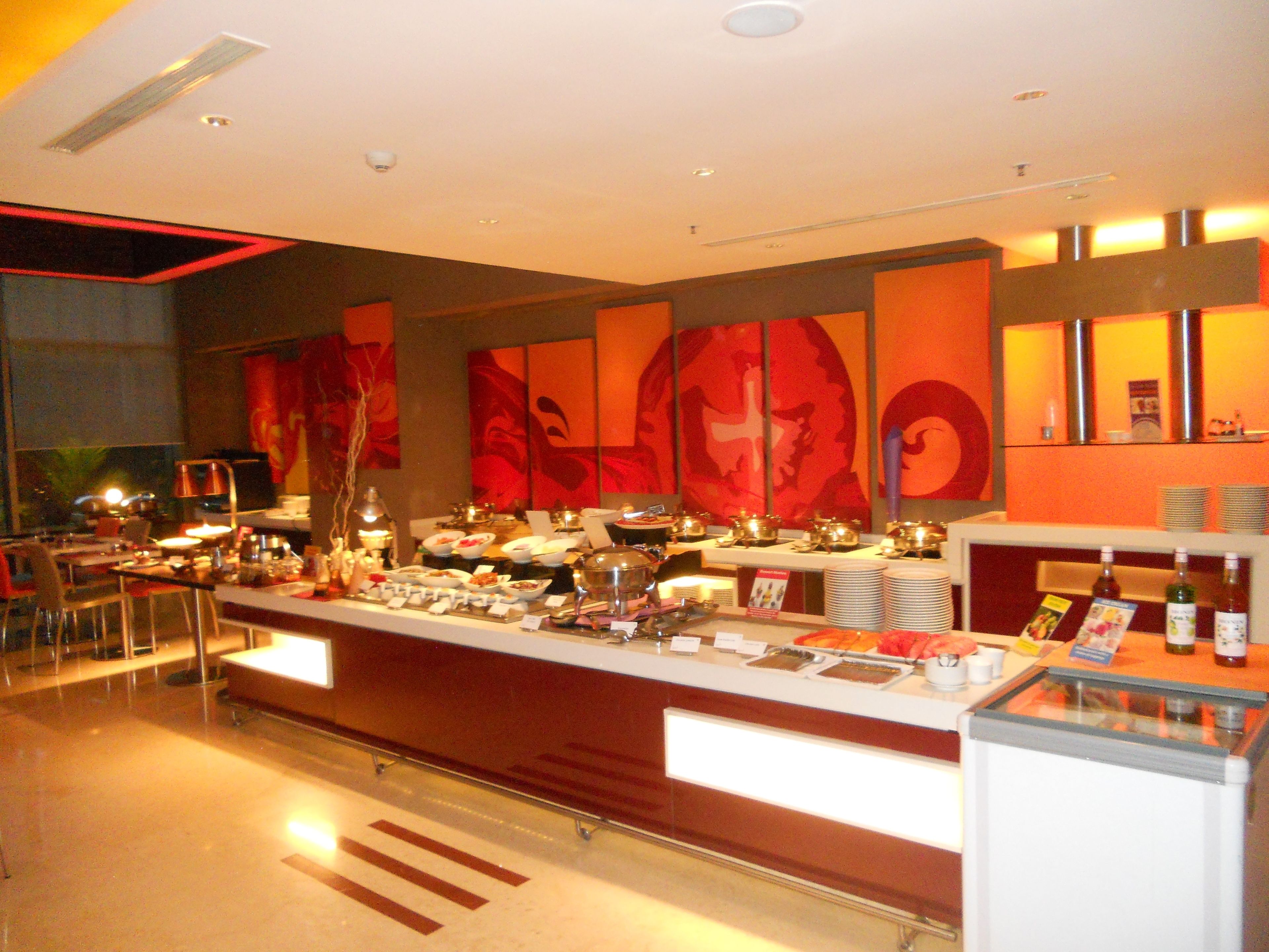 A buffet setup with various food items and a beverage station.